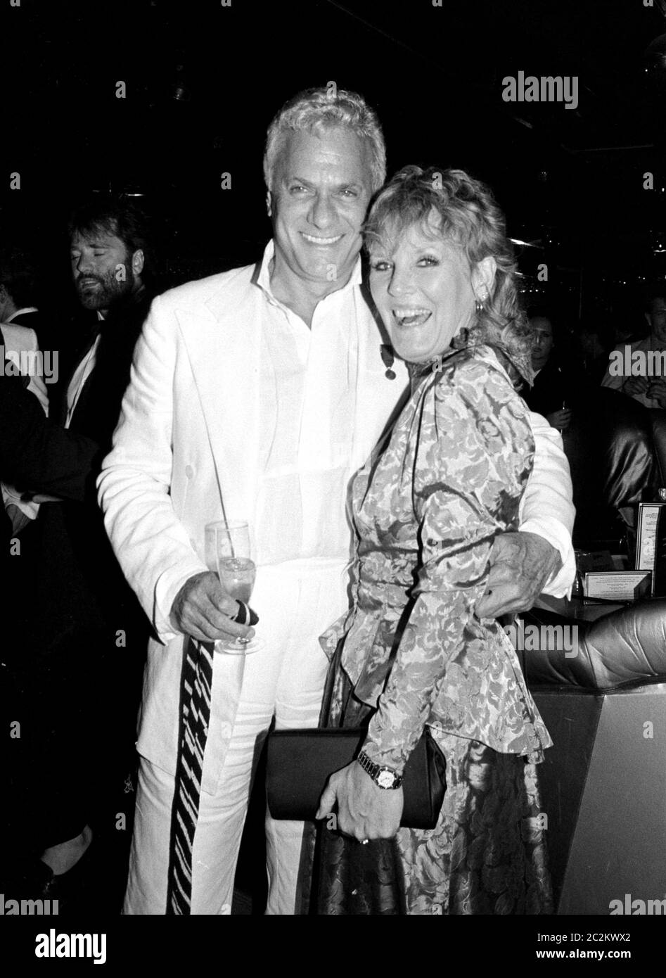 LONDON, UK. c. 1986: Actor Tony Curtis & singer Petula Clark at a party in London. © Paul Smith/Featureflash Stock Photo