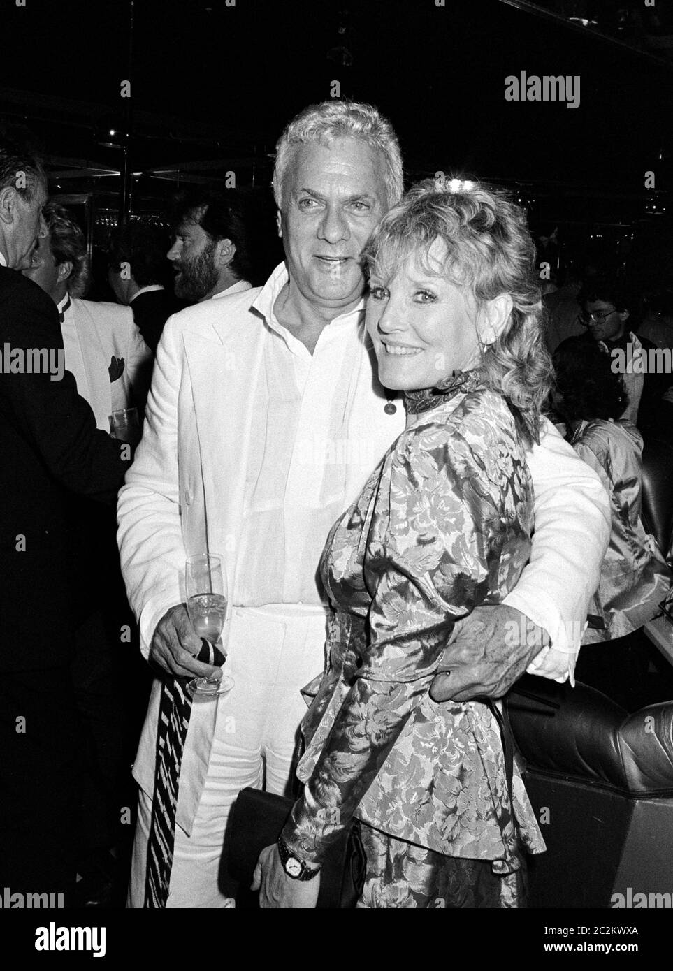 LONDON, UK. c. 1986: Actor Tony Curtis & singer Petula Clark at a party in London. © Paul Smith/Featureflash Stock Photo