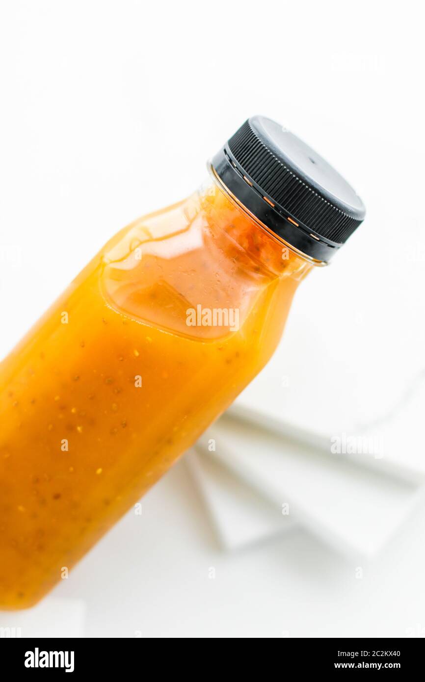 Detox fruit smoothie juice in a bottle, diet catering delivery. Isolated on white background