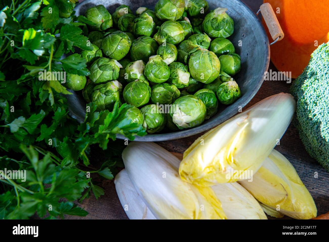 sprouts and endives on a wooden background, Belgian vegetables Stock Photo