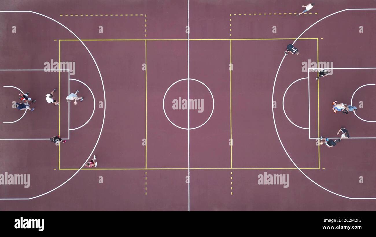 Men play basketball on the brown field. 4K video, 240fps, 2160p. Stock Photo
