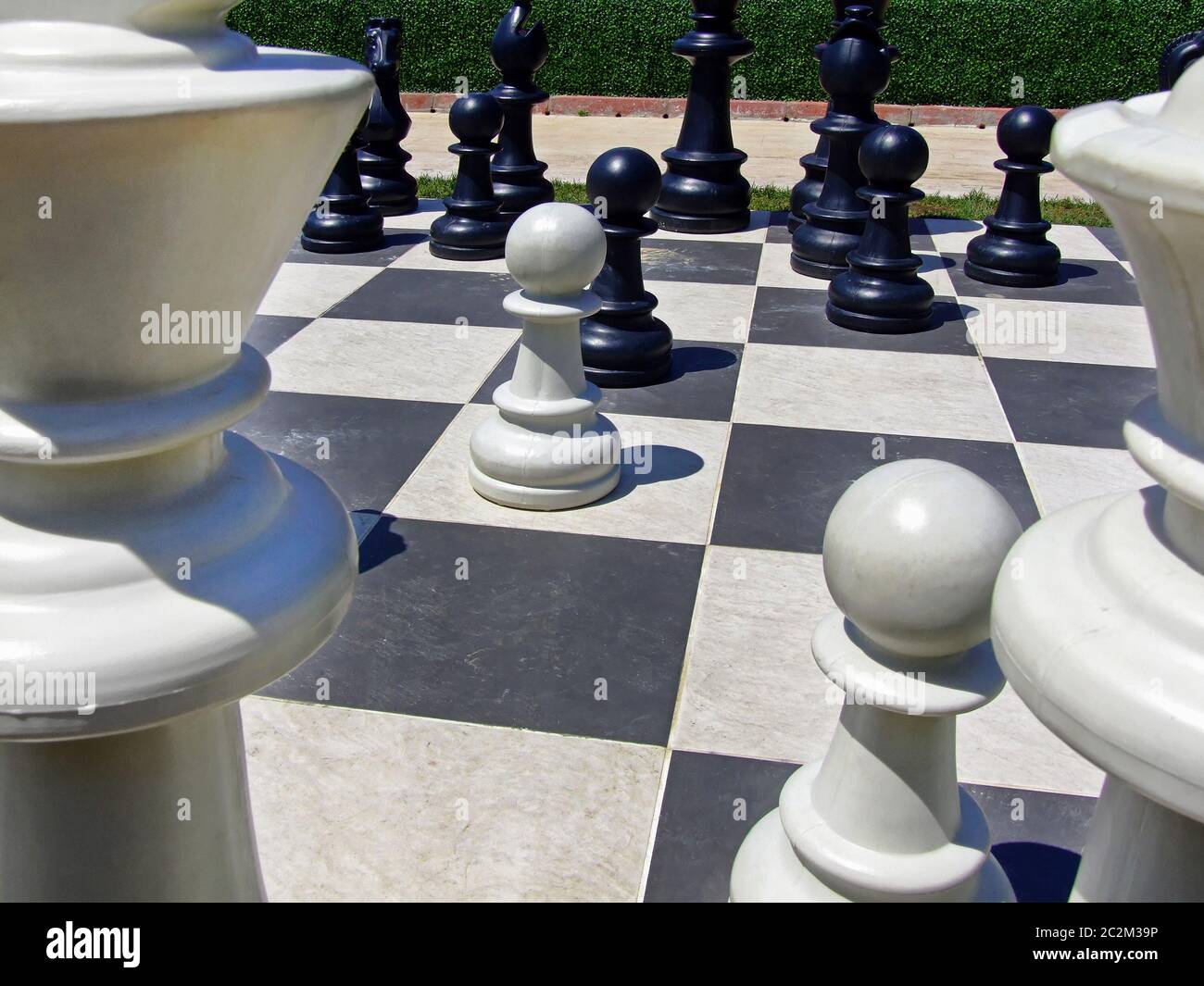 Giant chess board game set in the garden Stock Photo