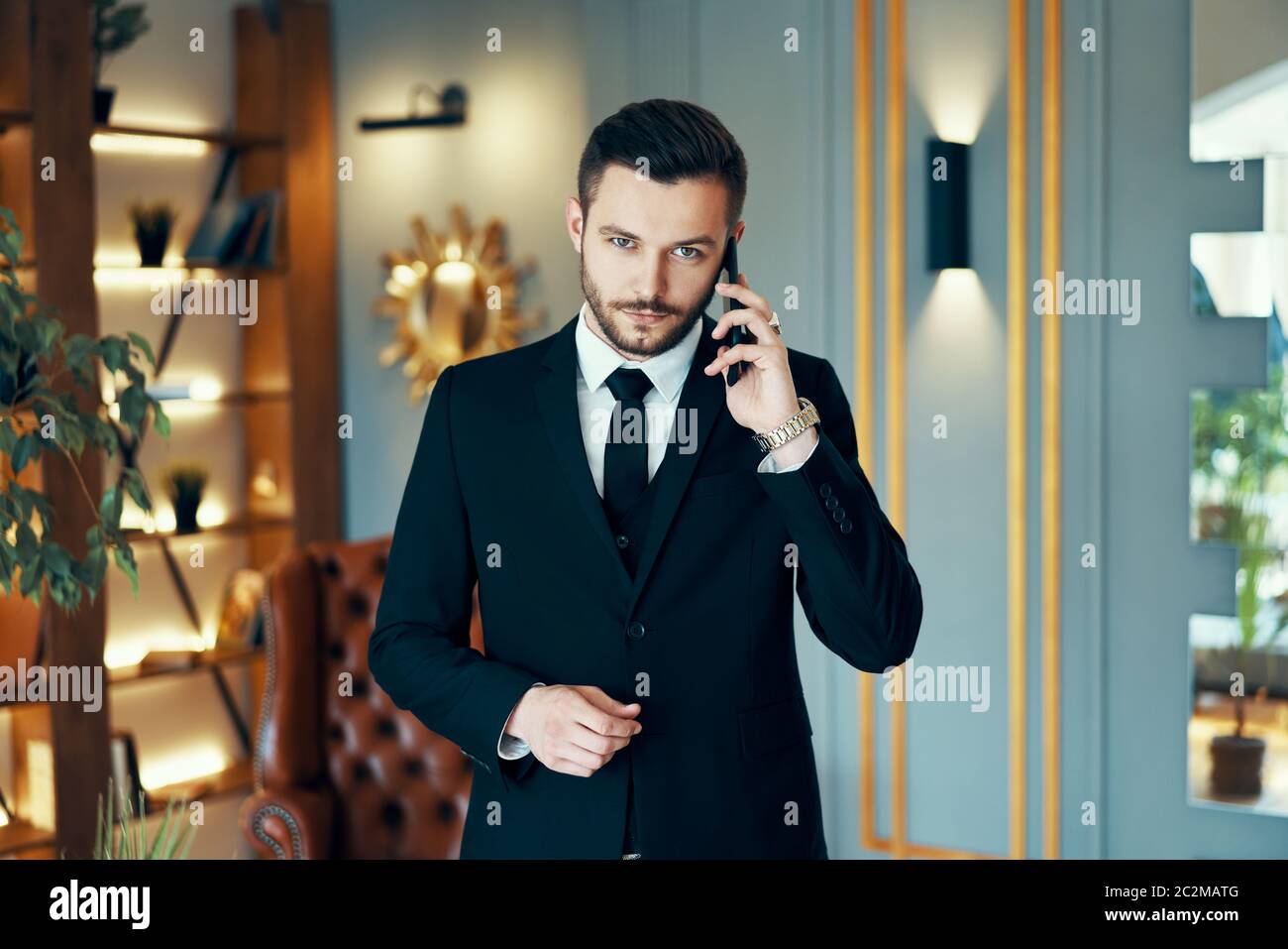 Young handsome businessman talking on mobile phone Stock Photo