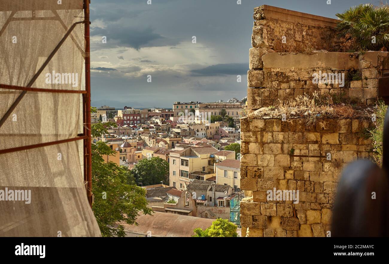 Glimpse filtered by a decaying wall of the city of Cagliari Stock Photo