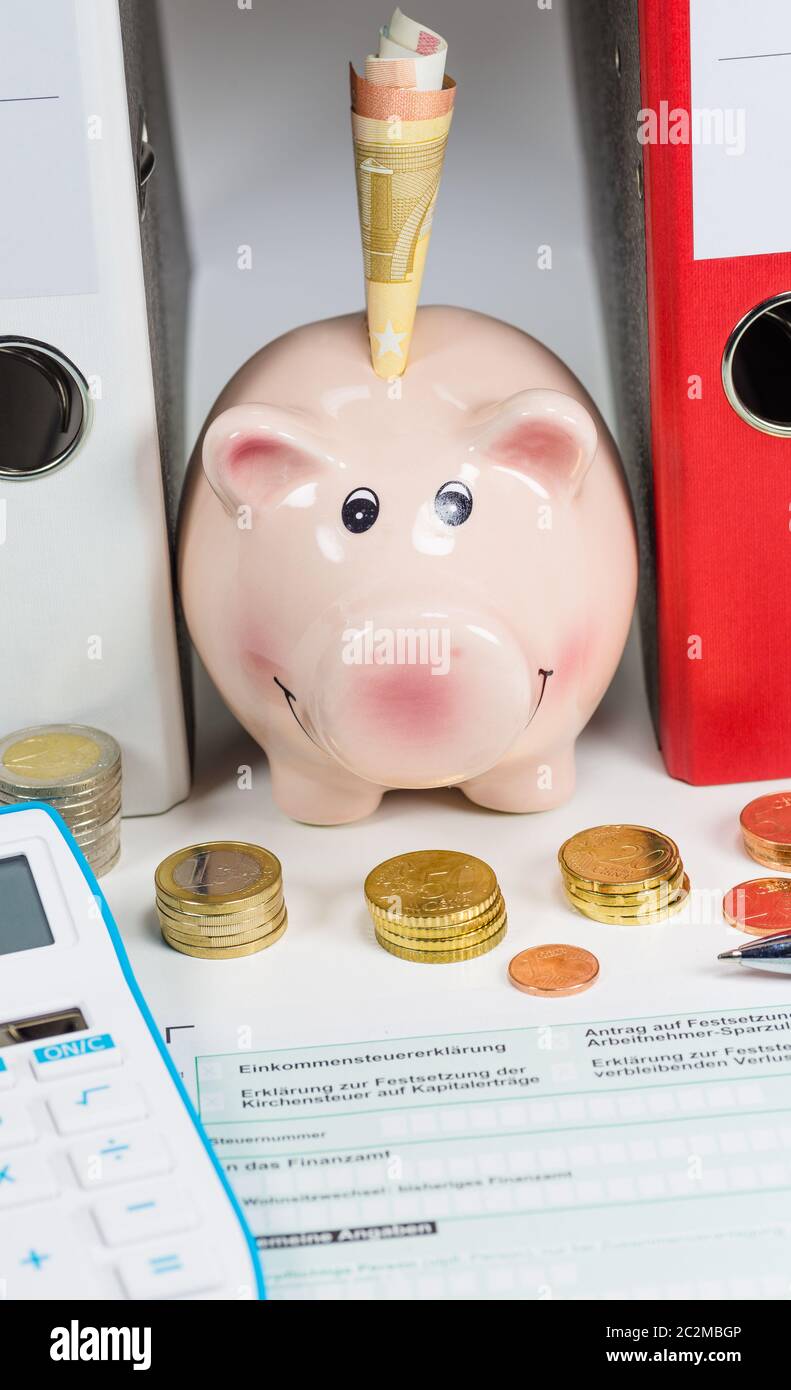 piggy bank with money and tax papers Stock Photo