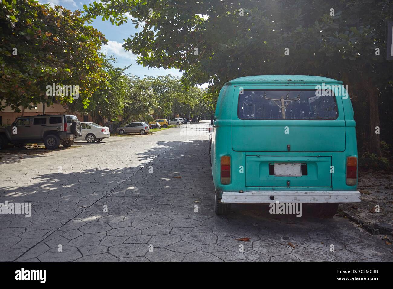 Old hippie van parked at the side of the road and taken from behind ...