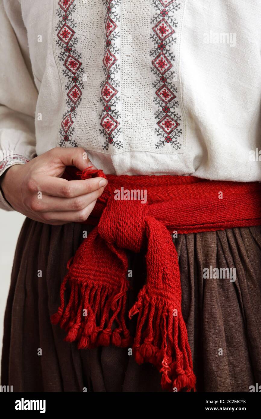 Folk costume. Cossack in an embroidered shirt with a red belt Stock Photo