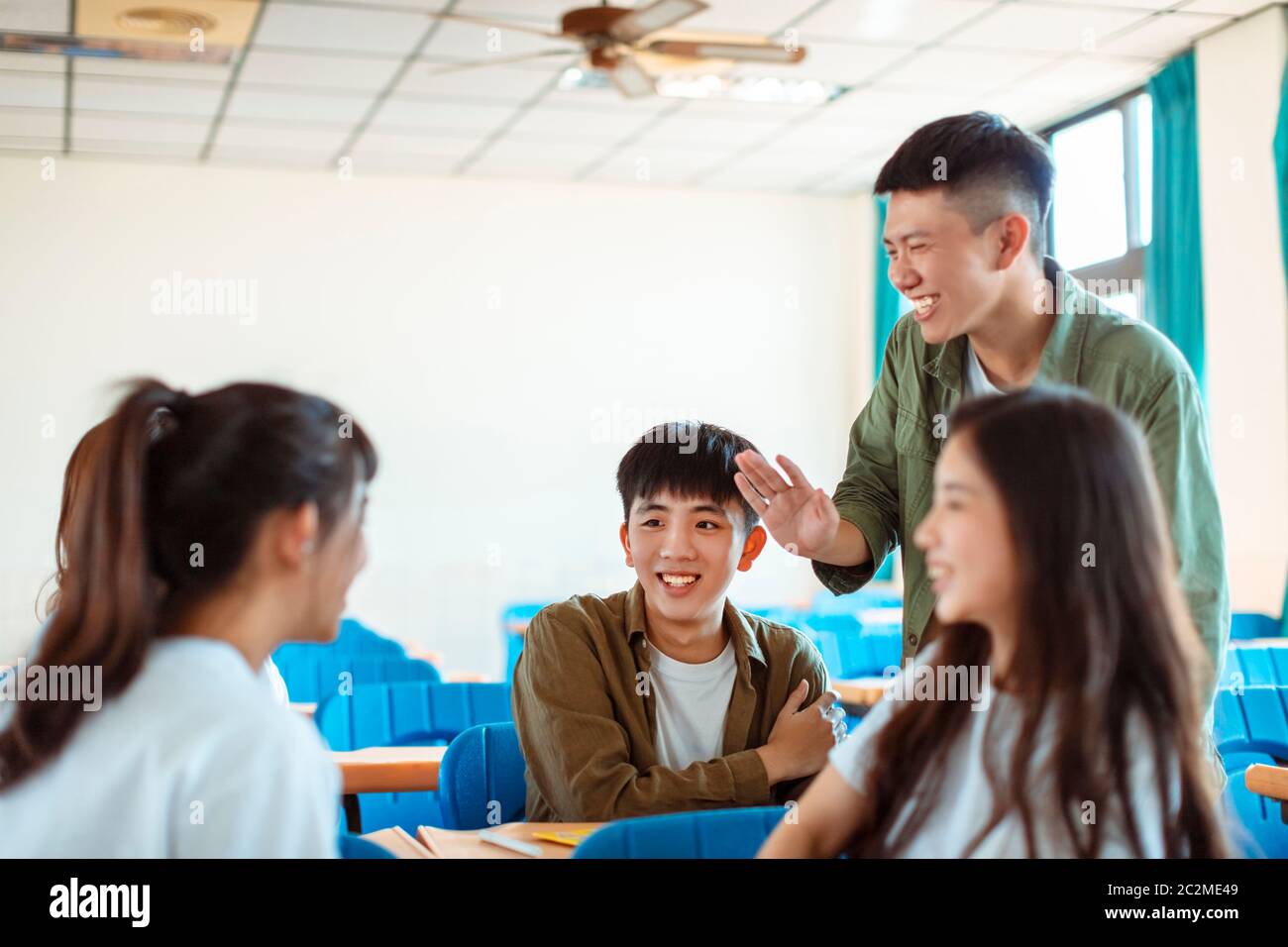 collage Student  discuss with Classmate in Classroom Stock Photo