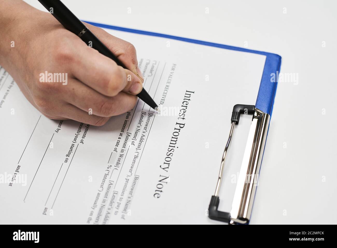 Filling and signing Interest Promissory Note document Stock Photo