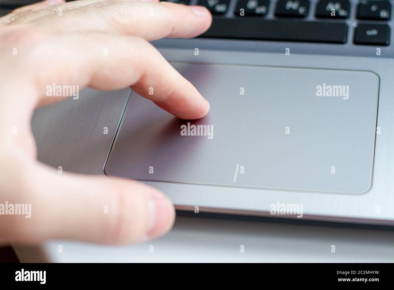 finger on silver laptop touchpad Stock Photo Alamy