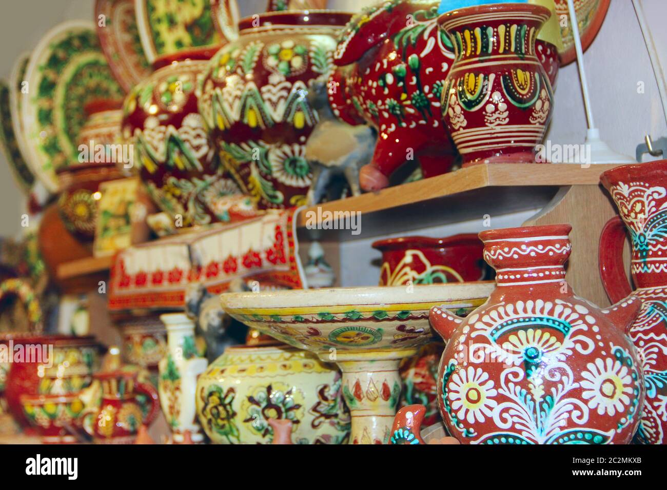 Wide choice of ceramic products on shelf of store. Pottery for sale. Ceramic goods Stock Photo