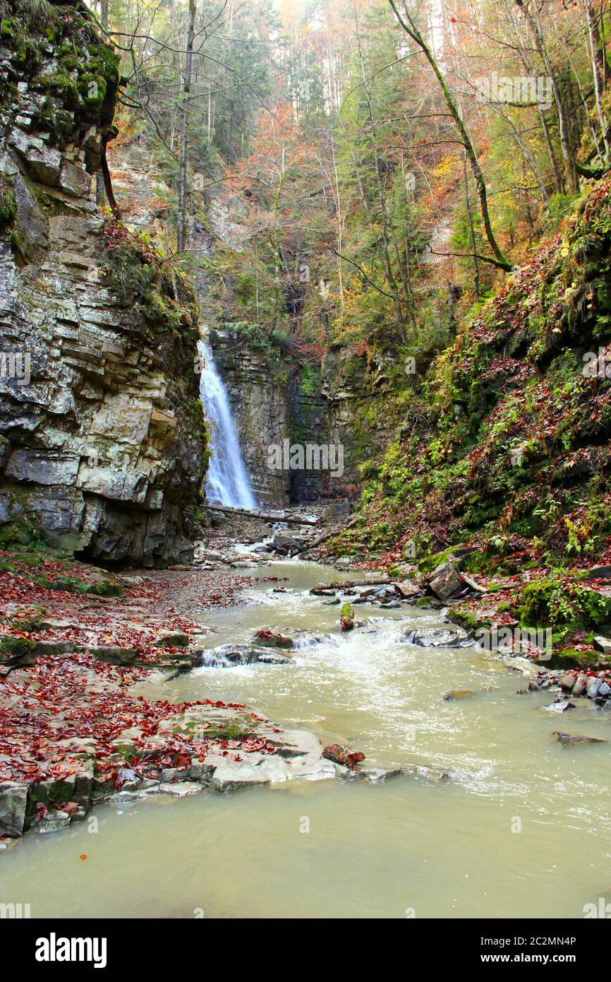 Waterfall with water falling from cliff. Manyavskii waterfall in