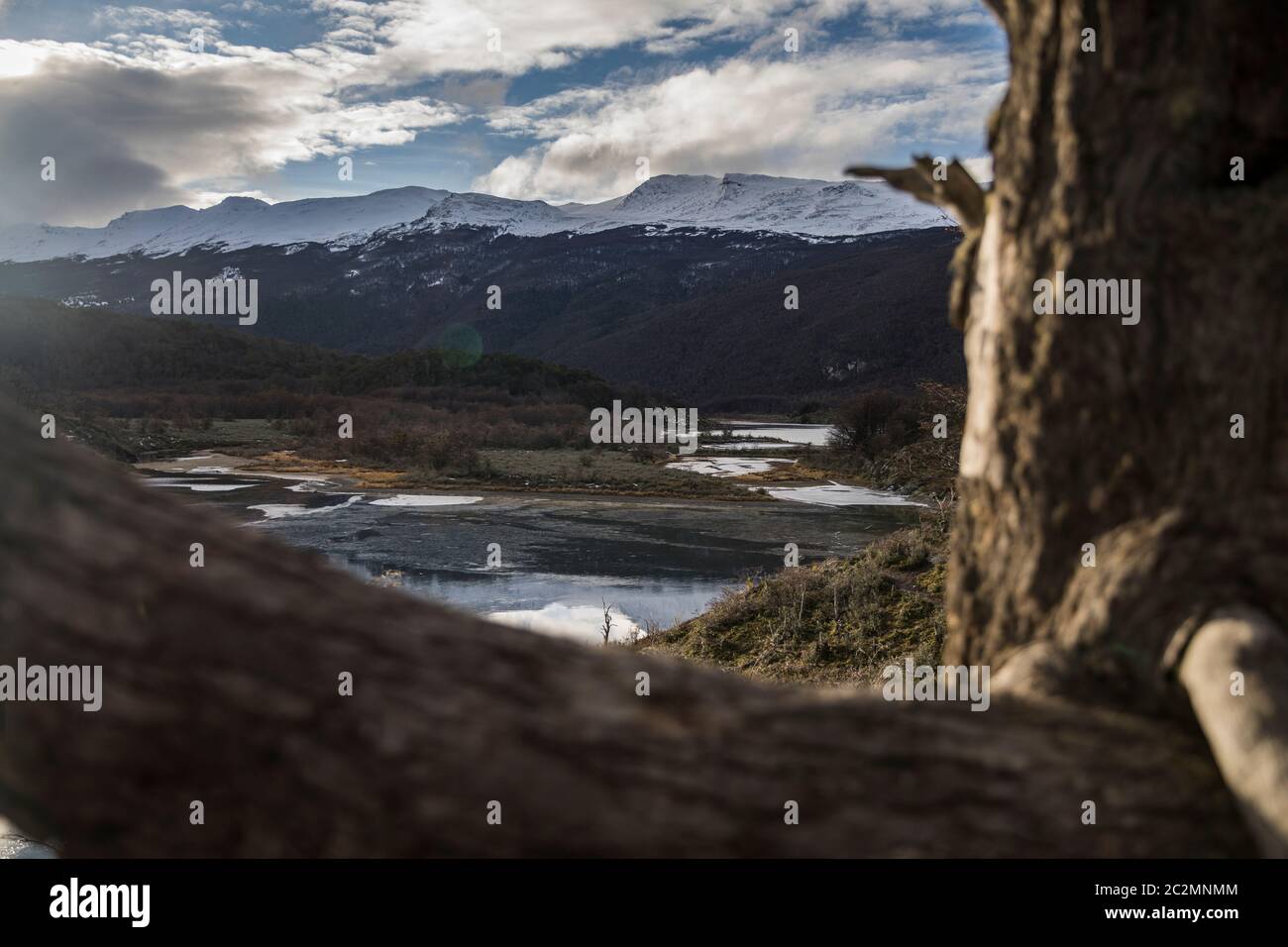 Landscape of a frozen lake and a mountain range in the background Stock Photo