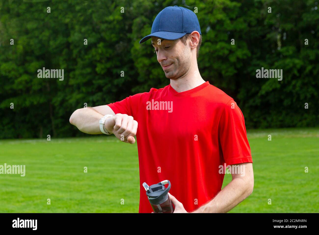 Surprised Sportsman check workout time on his watch Stock Photo Alamy