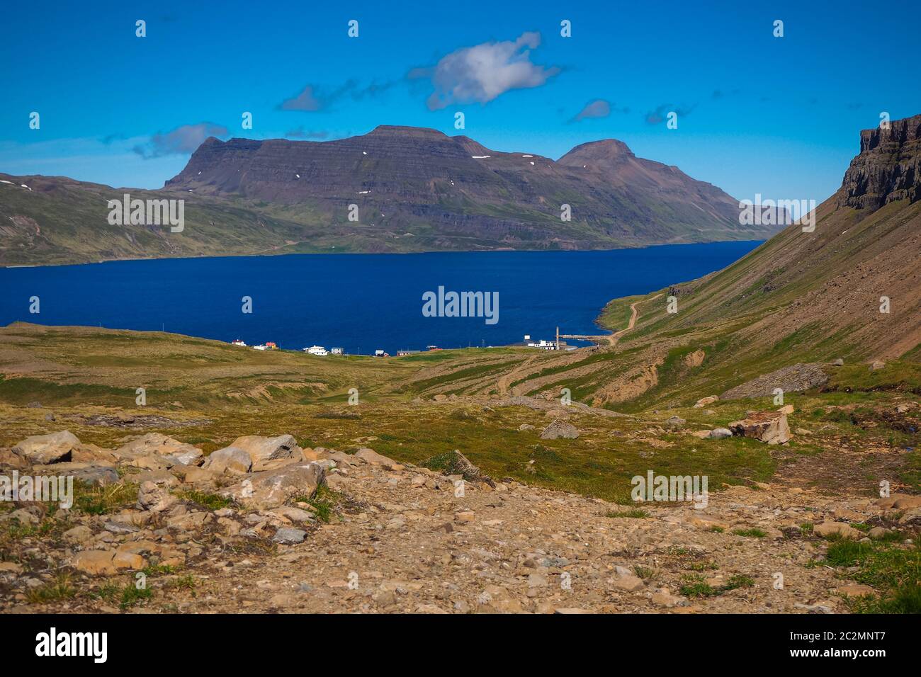 View over the tiny settlement of Djupavik to a fjord and mountains in the Westfjords of Iceland Stock Photo