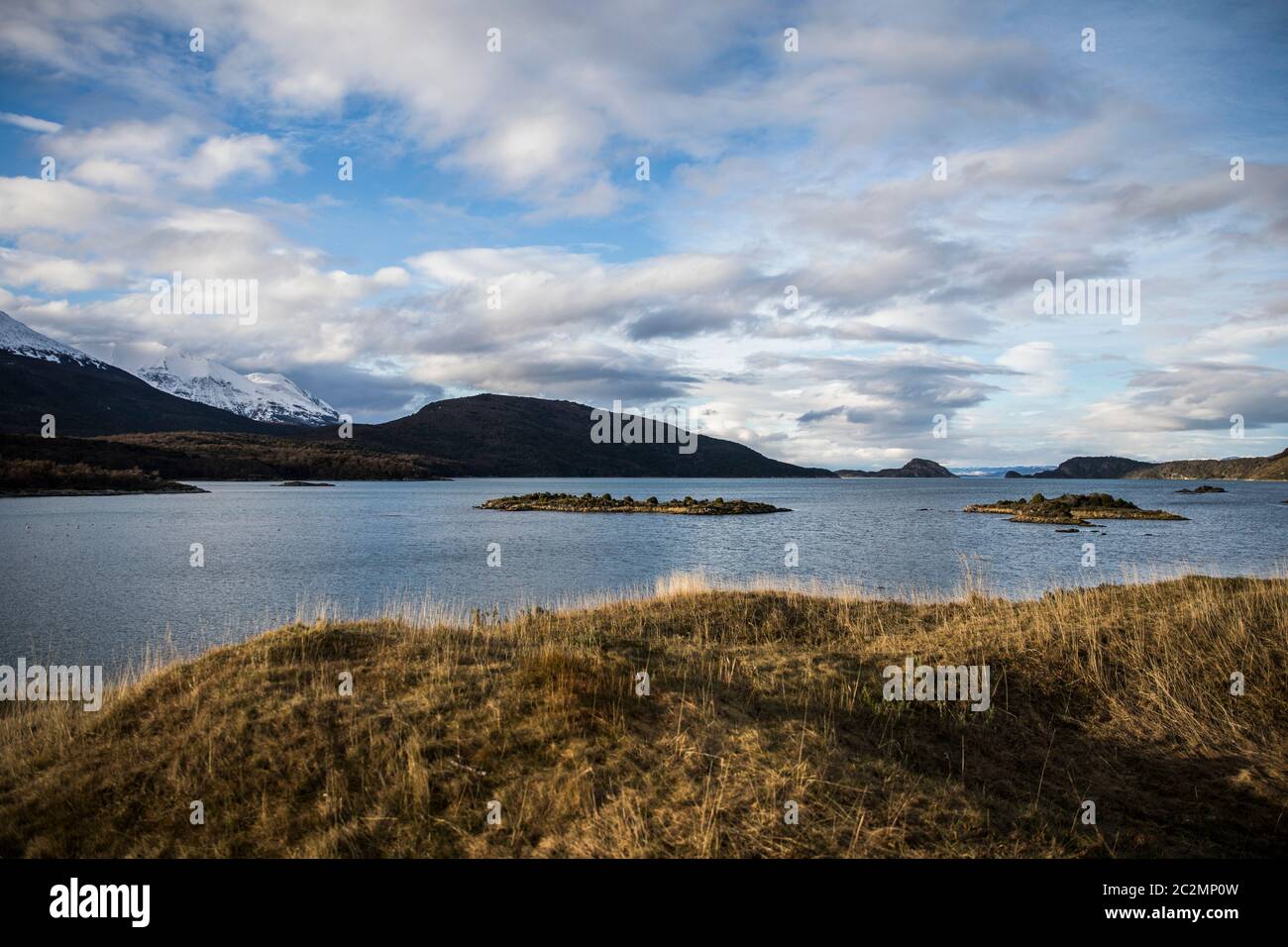 landscape of the ocean with a mountain range in the background Stock Photo
