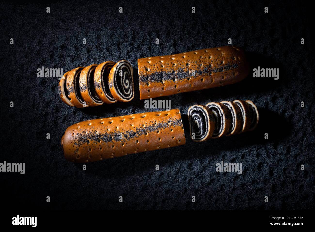 Christmas german poppy seed roll cake on poppy seeds texture background