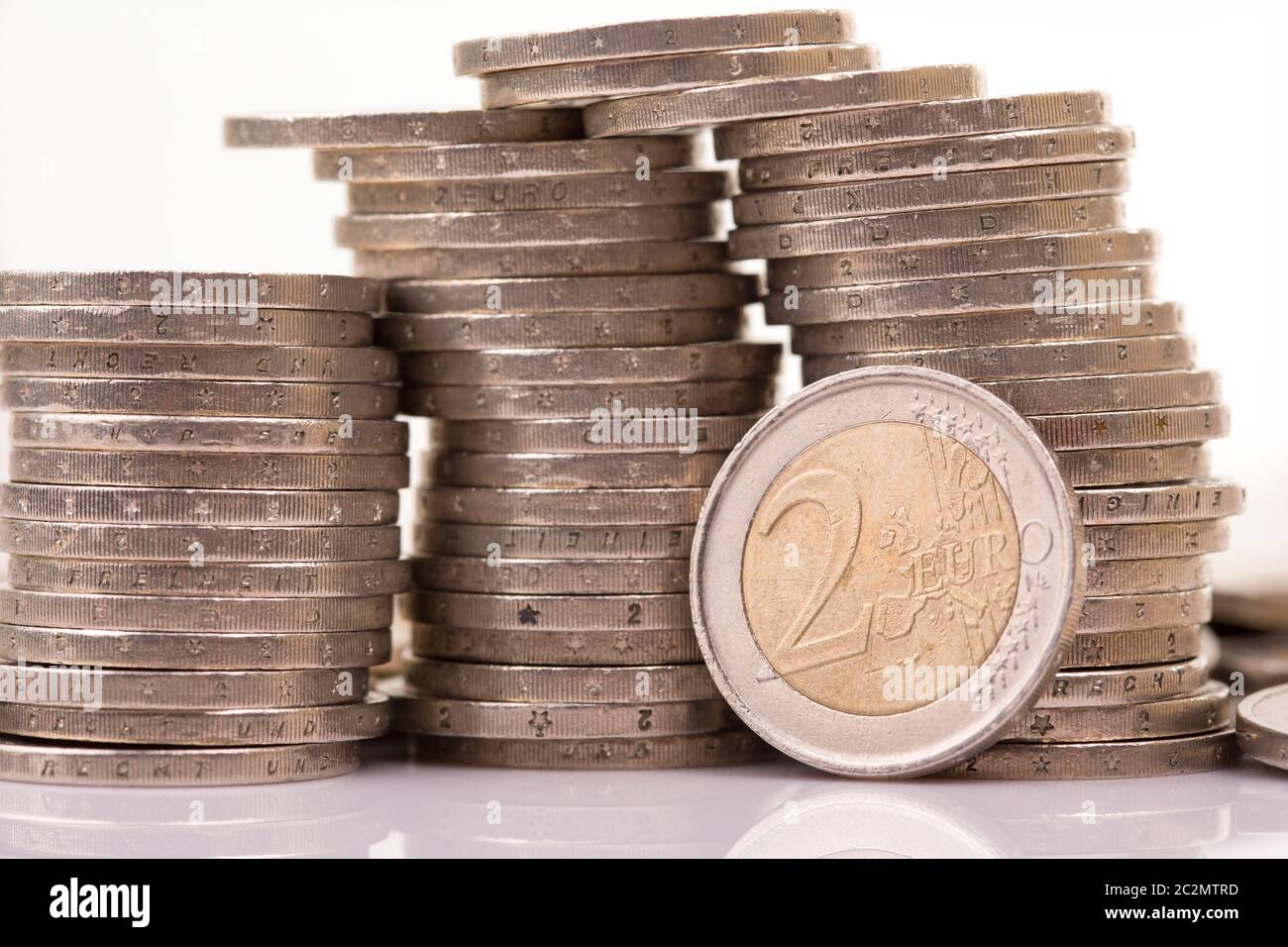 Heap of two euro coins isolated on white background Stock Photo - Alamy