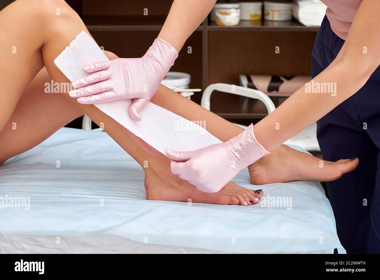The process of female waxing. Beautician Waxing A Woman's Leg Applying Wax Strip. Beautician removes wax with hair from female legs Stock Photo - Alamy The process of female waxing. Beautician Waxing A Woman's Leg Applying Wax Strip. Beautician removes wax with hair from female legs Stock Photo - Alamy