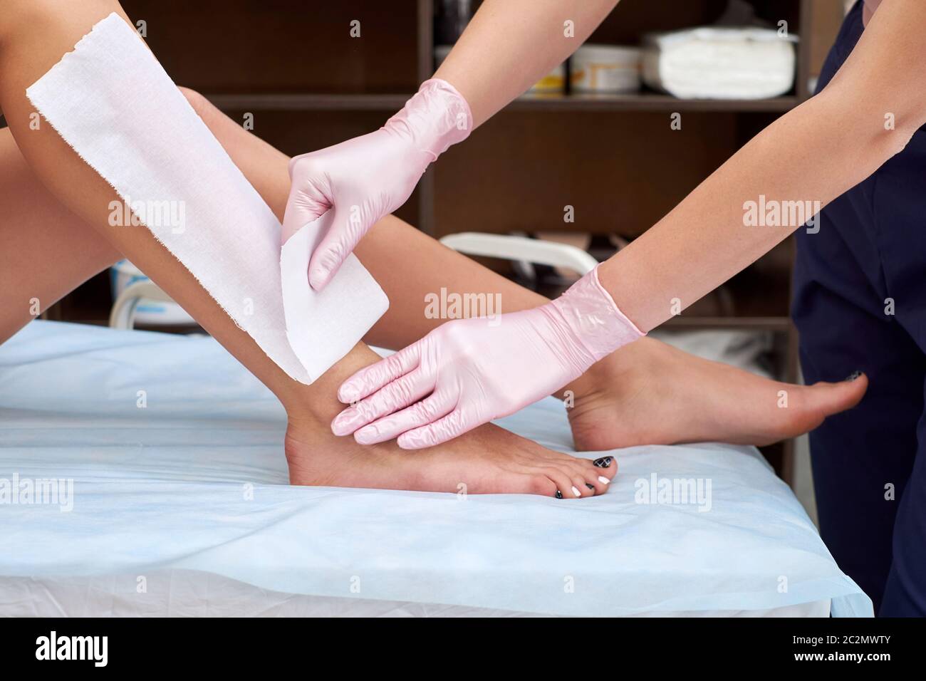 The process of female waxing. Beautician Waxing A Woman's Leg Applying Wax Strip. Beautician removes wax with hair from female legs Stock Photo - Alamy The process of female waxing. Beautician Waxing A Woman's Leg Applying Wax Strip. Beautician removes wax with hair from female legs Stock Photo - Alamy
