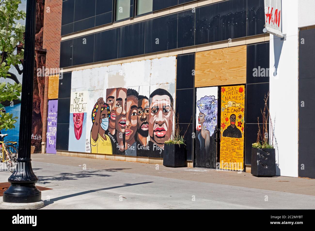 Boarded windows with paintings of black men killed by police: Floyd, Castile, Rice, Taylor and Garner. Minneapolis Minnesota MN USA Stock Photo