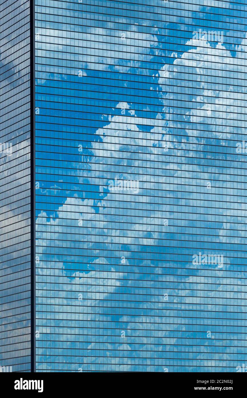 Clouds reflected in windows of modern office building Stock Photo - Alamy