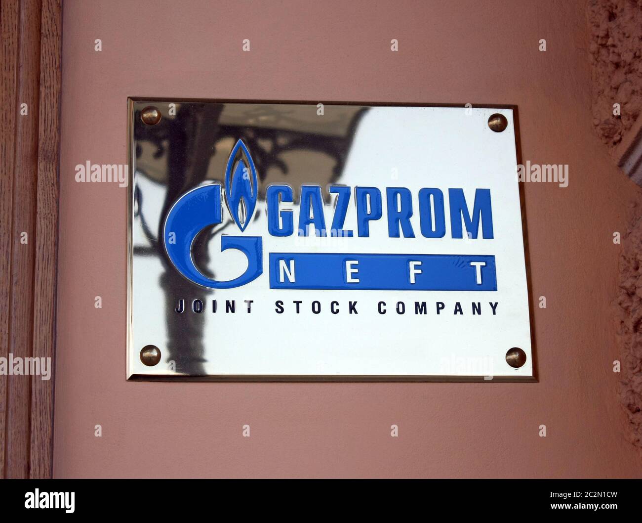 ST-PETERSBURG, RUSSIA, AUG 04, 2013: GAZPROM logo metal plate on the facade of building. Open Joint Stock Company Gazprom is the Stock Photo