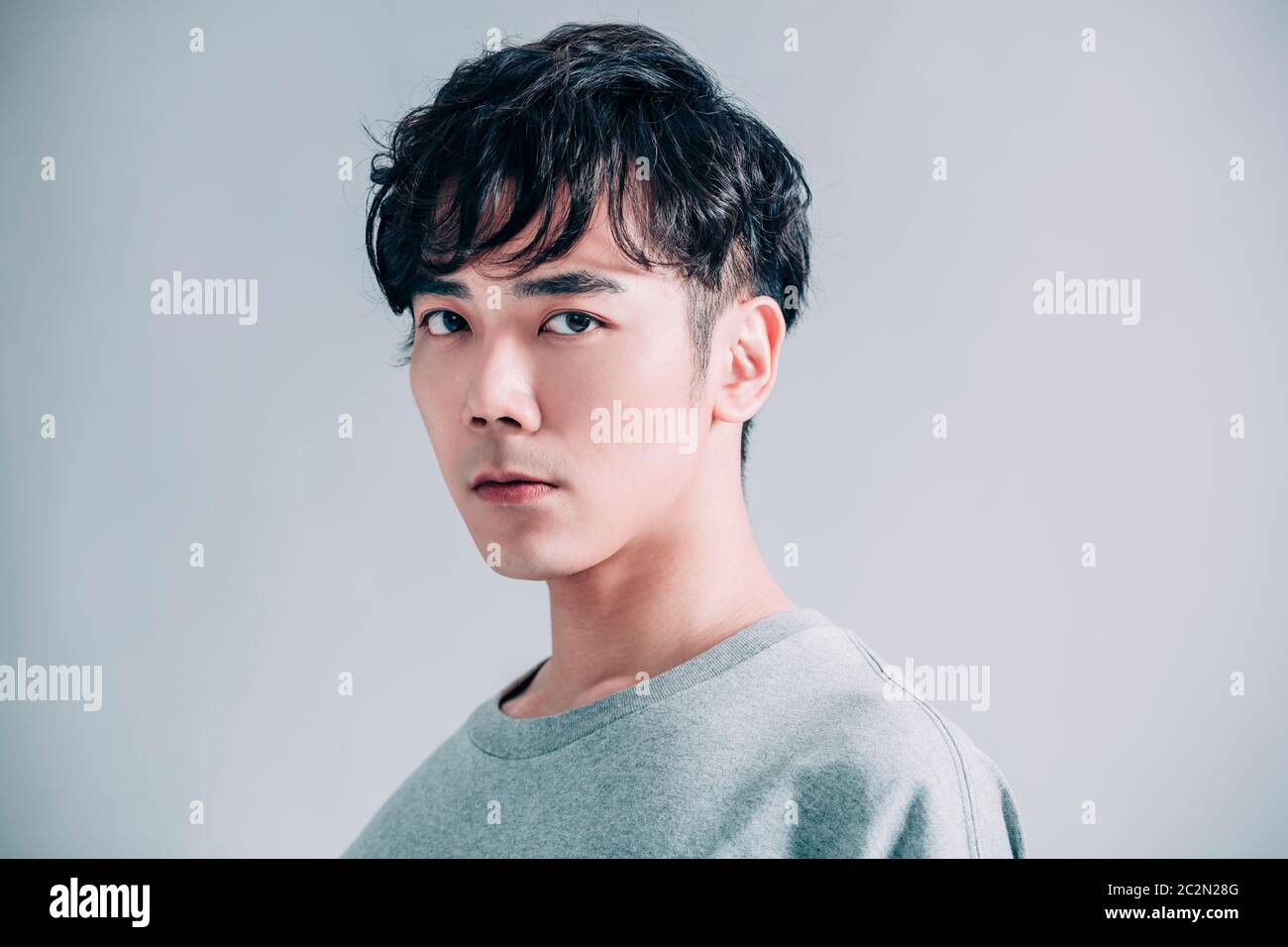 portrait of young handsome man isolated on gray background Stock Photo ...
