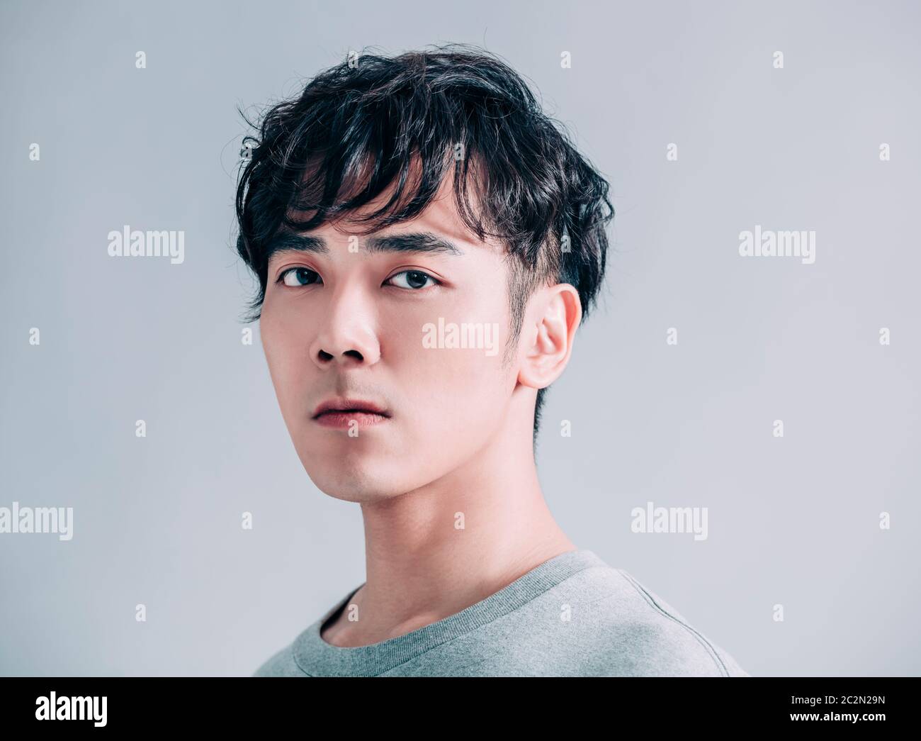 portrait of young handsome man isolated on gray background Stock Photo ...
