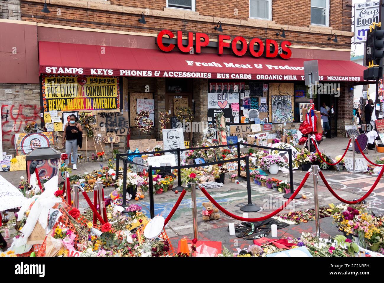 Roped off area where George Floyd was suffocated by Police on 38th & Chicago in front of Cup Foods filled with flowers. Minneapolis Minnesota MN USA Stock Photo