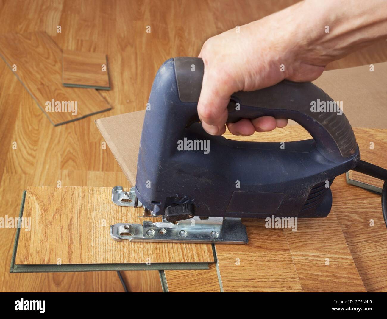 Master using an electric jigsaw saws laminated panel Stock Photo Alamy