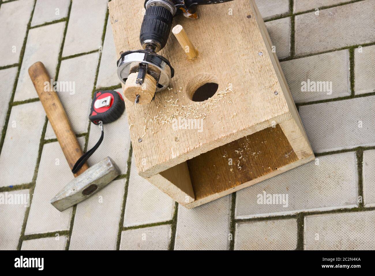 Drilling holes in the birdhouse Stock Photo
