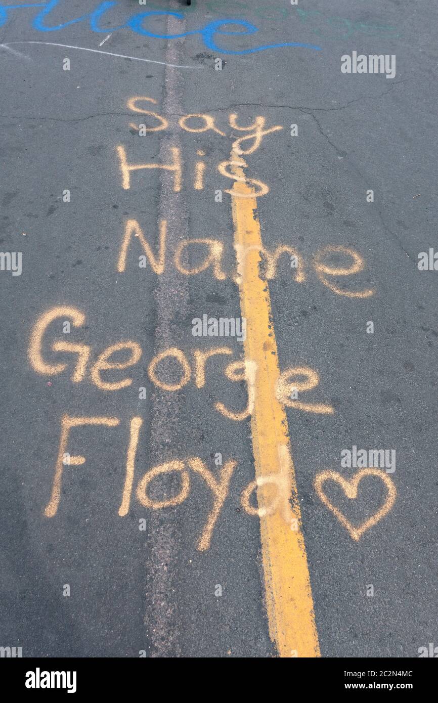 Admonition 'Say His Name: George Floyd' statement on pavement at 38th and Chicago where he died. Minneapolis Minnesota MN USA Stock Photo
