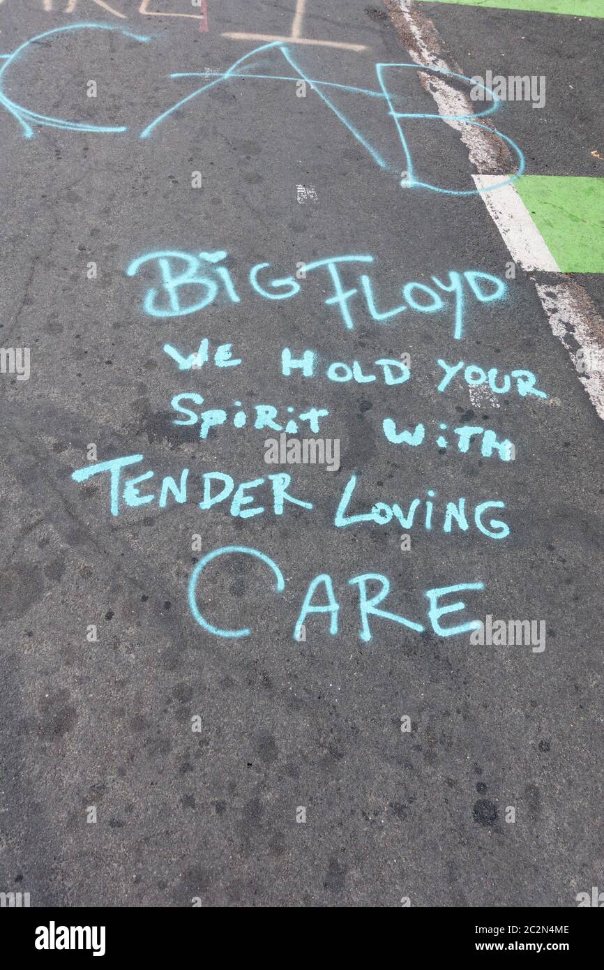 BIG FLOYD We hold your spirit with Tender Loving CARE statement on pavement at 38th & Chicago where George Floyd died. Minneapolis Minnesota MN USA Stock Photo