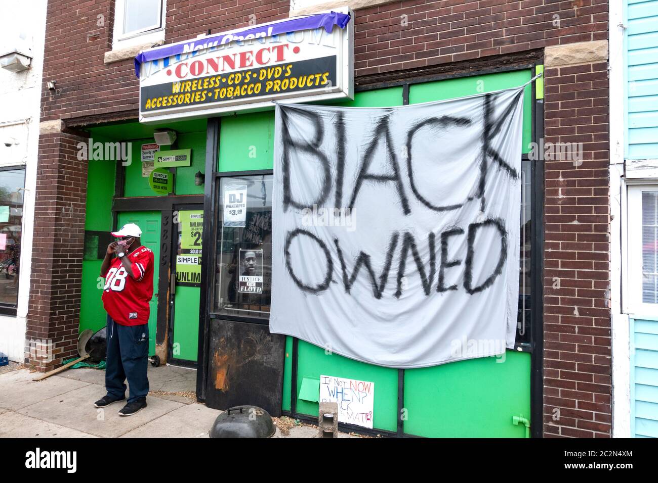Large 'Black Owned' banner pleading with arsonists and looters to bypass his business at George Floyd memorial site. Minneapolis Minnesota MN USA Stock Photo