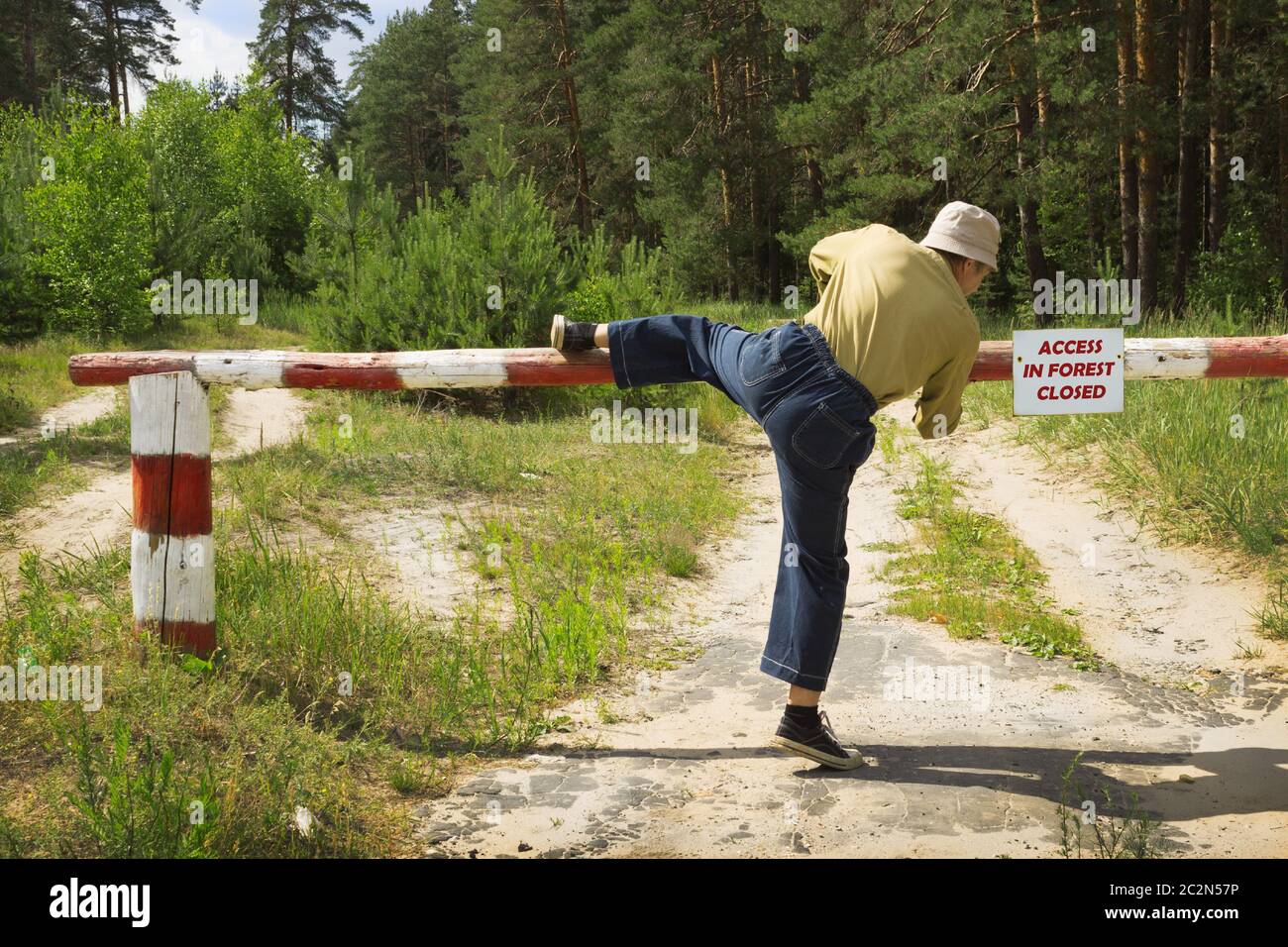 Man overcomes barrier in fire-dangerous period, ignoring ban Stock Photo