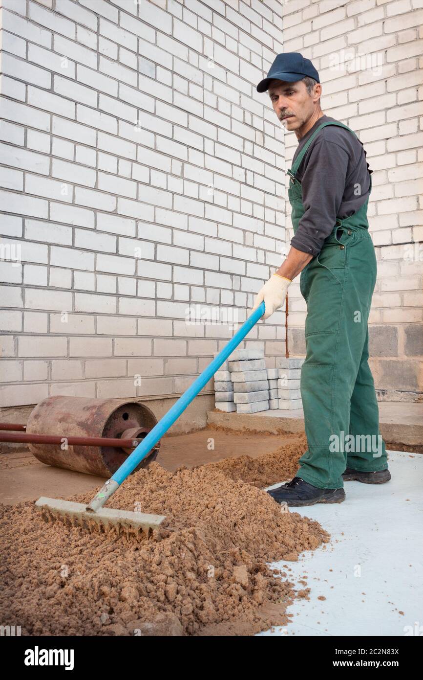 Leveling the ground before laying paving stones Stock Photo Alamy