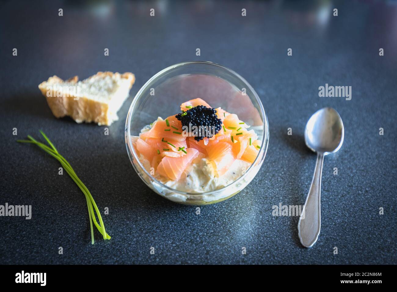 verrine salmon lumpfish egg fresh cheese and avocado bed in the kitchen Stock Photo
