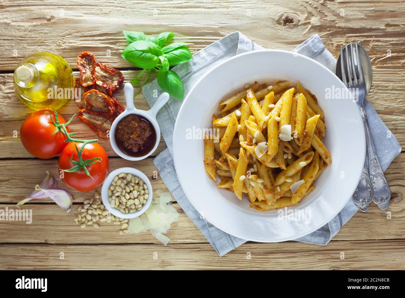 Pasta With Pesto Rosso On A Wooden Background Stock Photo