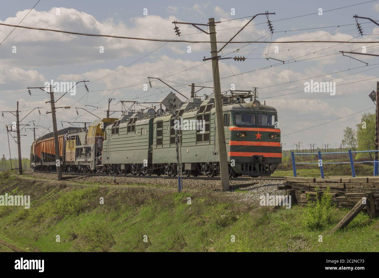 Green freight train transports cargo by rail Stock Photo