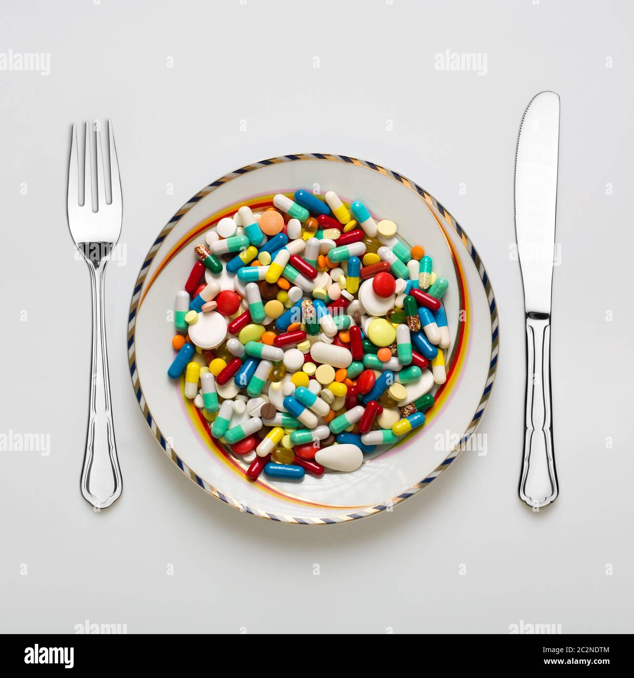 Medical dinner set with silverware and pills Stock Photo Alamy