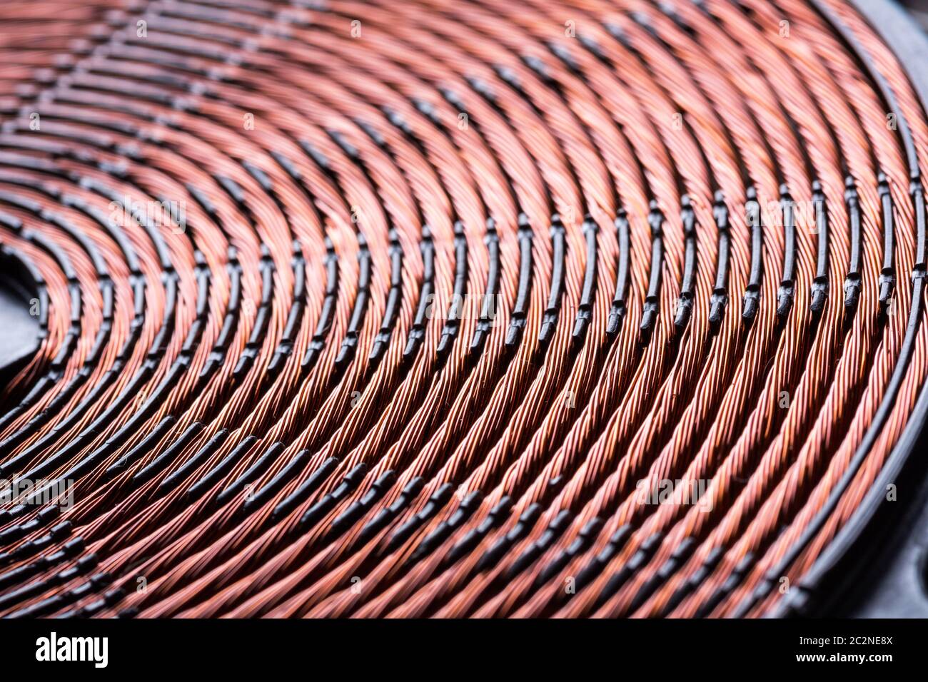 Induction heater copper coil closeup. Electric wires macro detail Stock