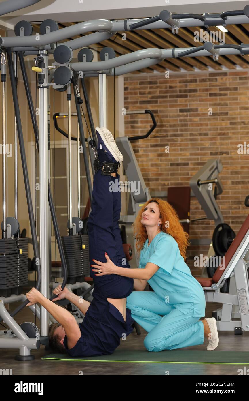 Physiotherapist helps patient to rehabilitate Stock Photo