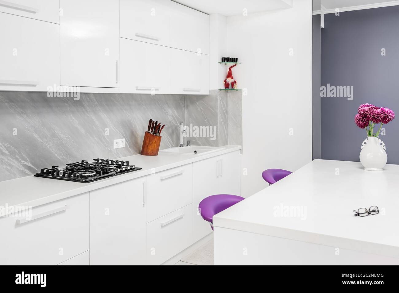 modern kitchen with dining table and purple chairs Stock Photo Alamy
