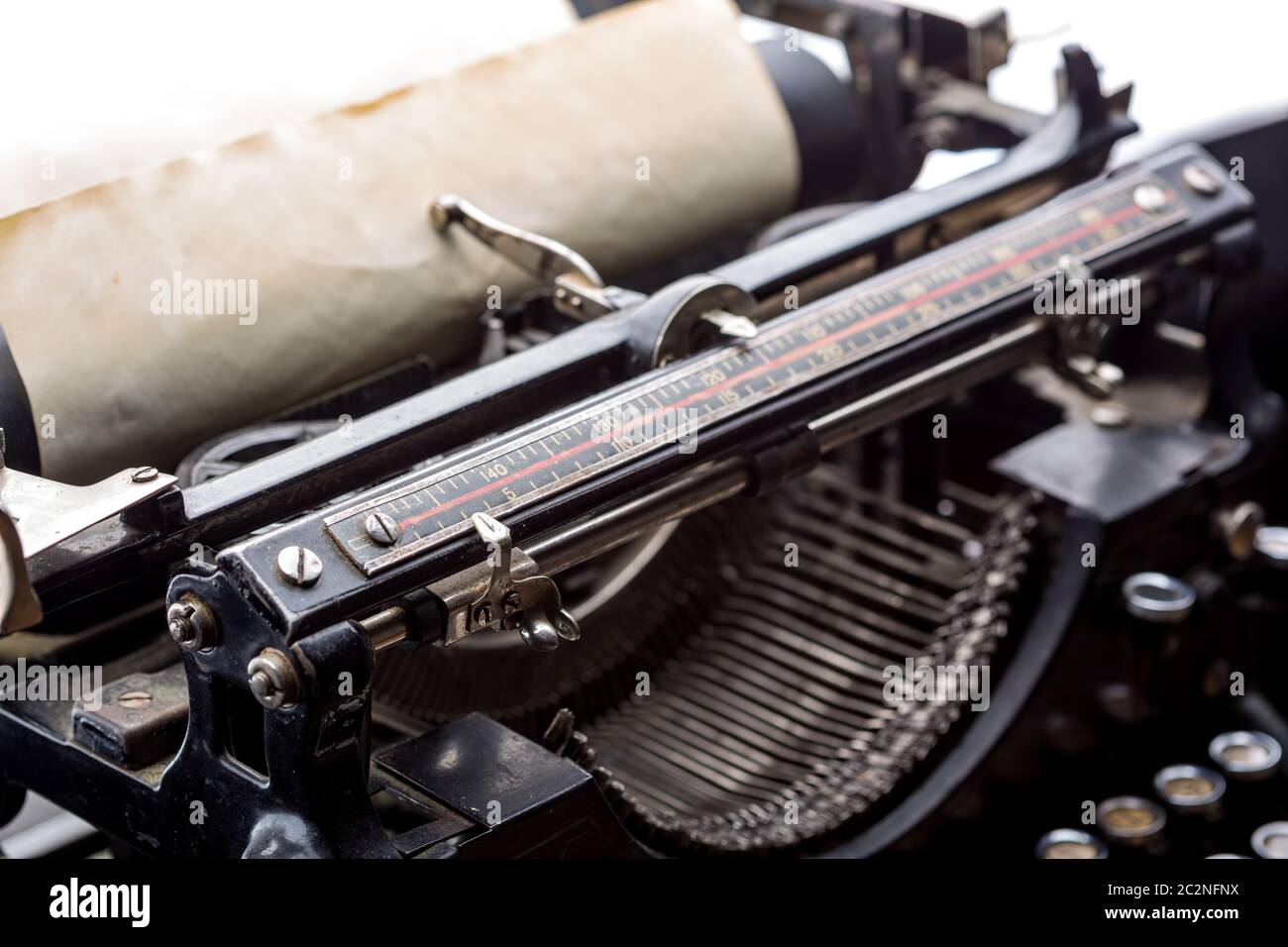 Vintage typewriter ribbon mechanism with inserted old paper closeup