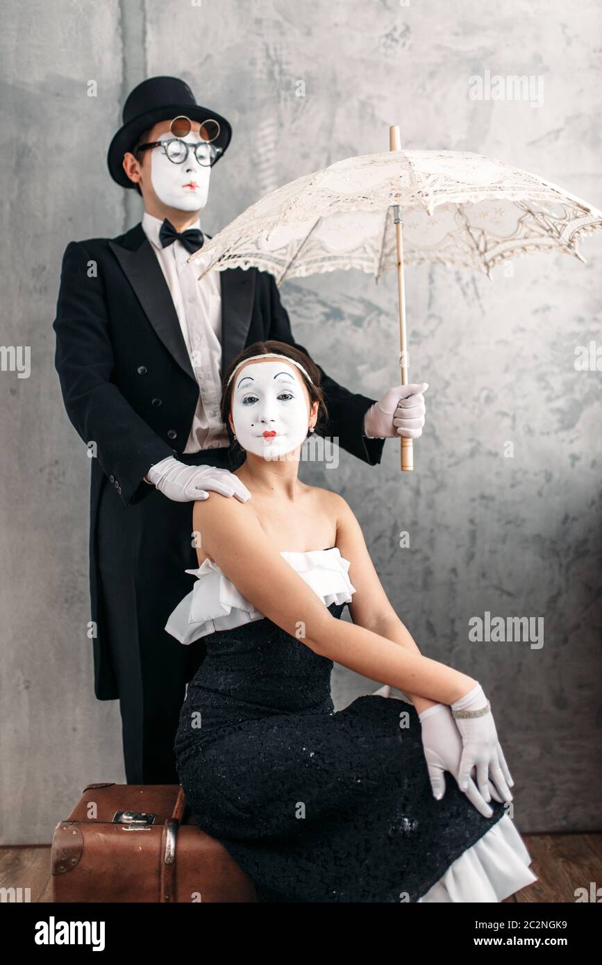 Pantomime theater performers posing with vintage umbrella. Mime actors ...