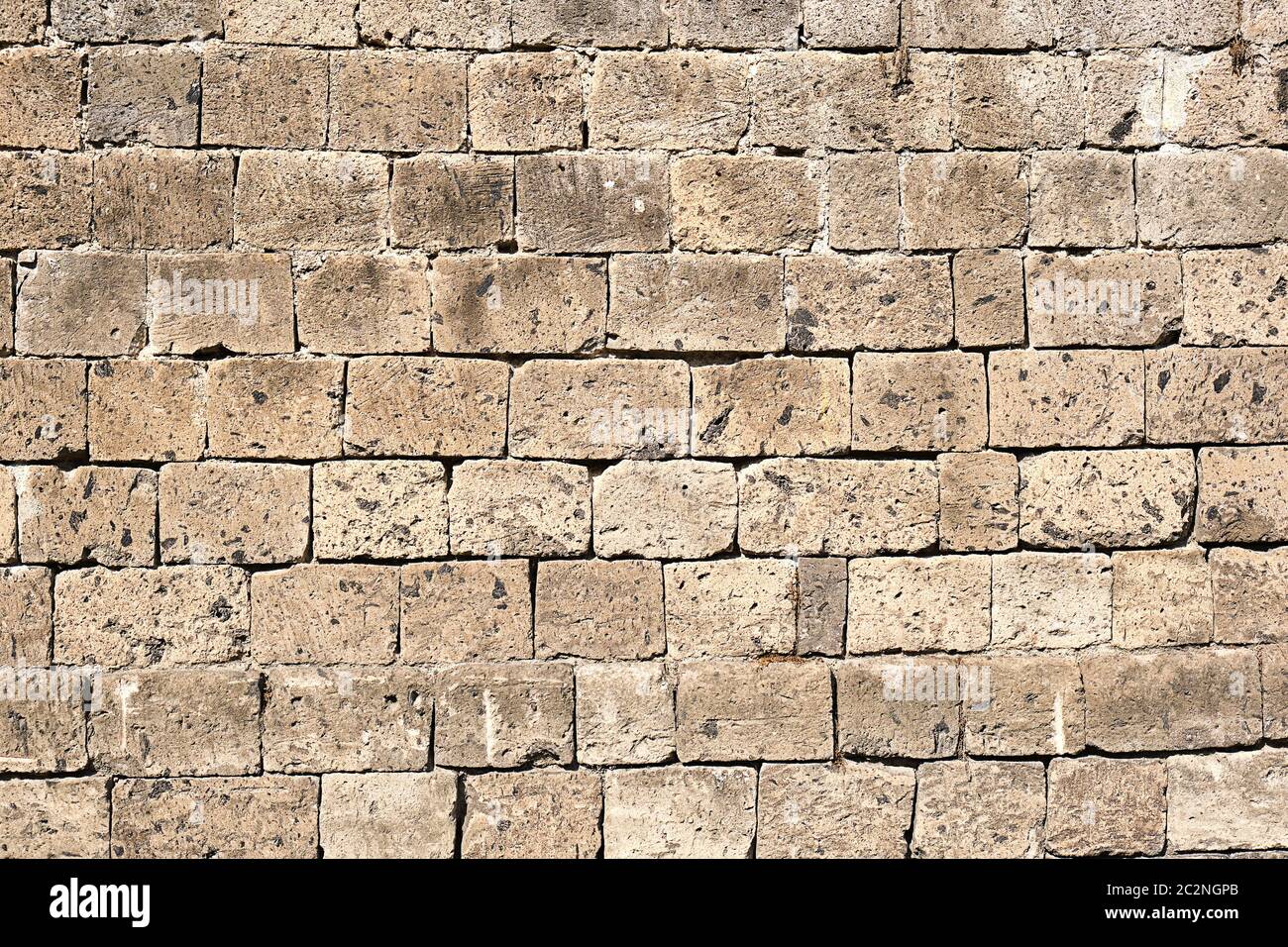 Background from a beige natural stone wall Stock Photo