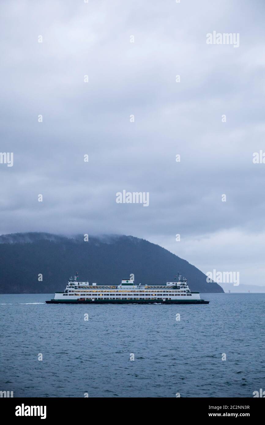 A Washington State Ferry under sail on a cloudy day in the San Juan Islands, Washington, USA. Stock Photo