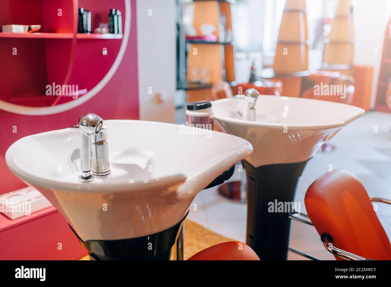 Modern wash basins in hairdressing salon, nobody. Professional