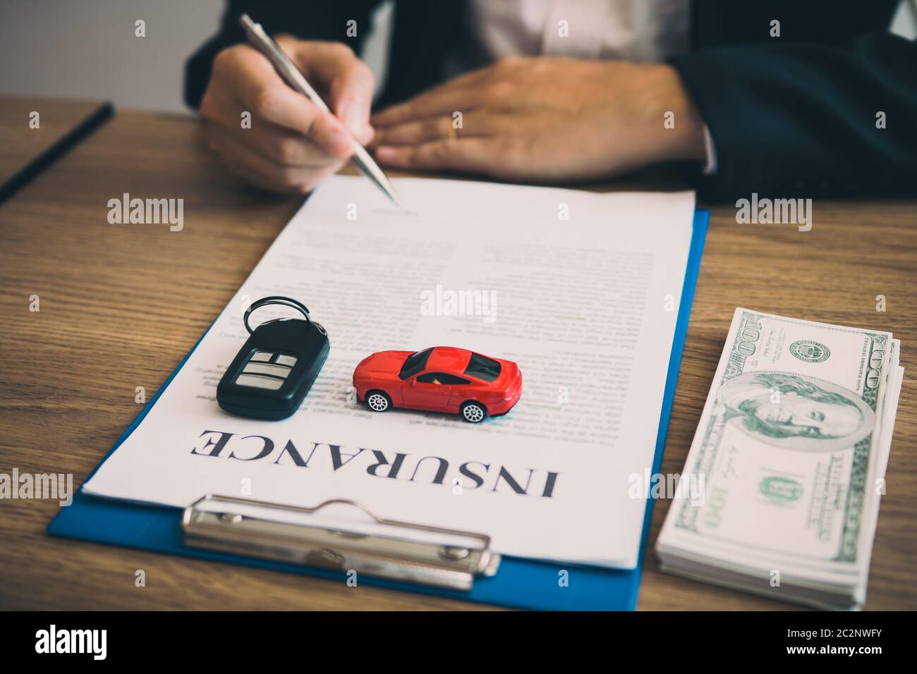 Agent Is Signing The Insurance Contract For The Car At The Document On The Desk Stock Photo Alamy